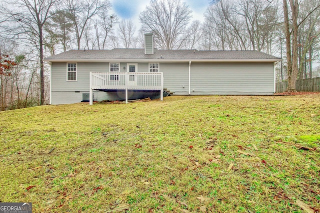 rear view of property with a yard, a deck, and central air condition unit