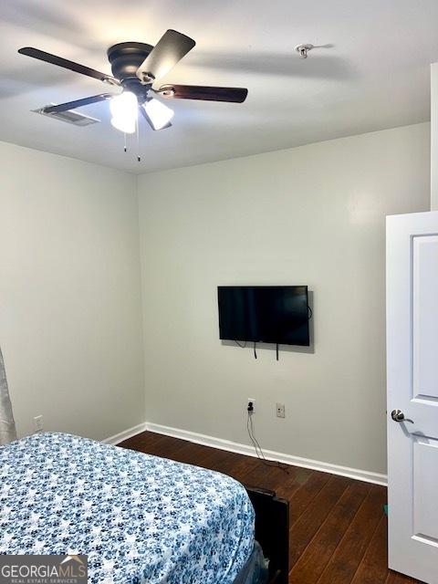 bedroom featuring ceiling fan and dark hardwood / wood-style flooring