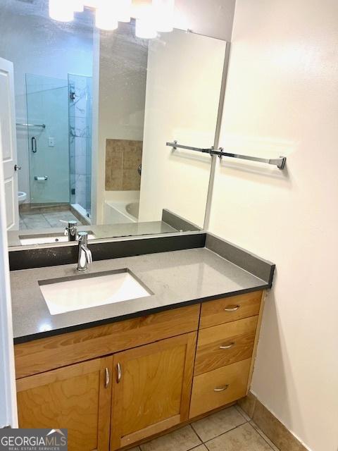 bathroom with vanity, separate shower and tub, and tile patterned flooring