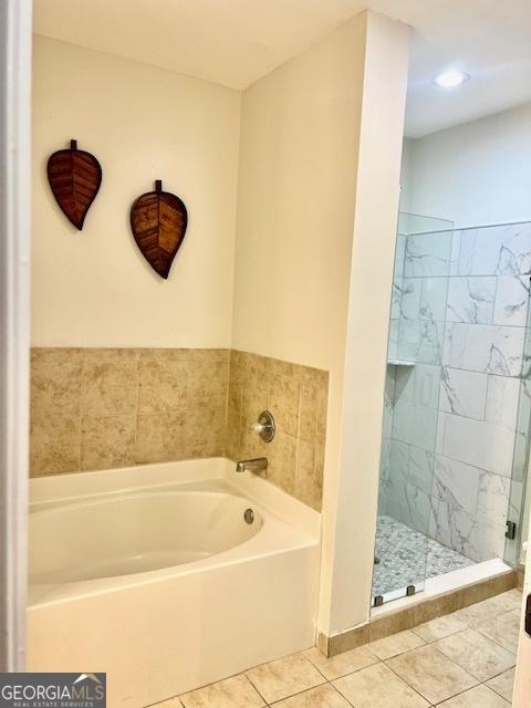 bathroom featuring tile patterned flooring and plus walk in shower