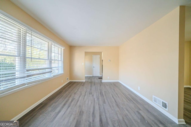 unfurnished room with wood-type flooring