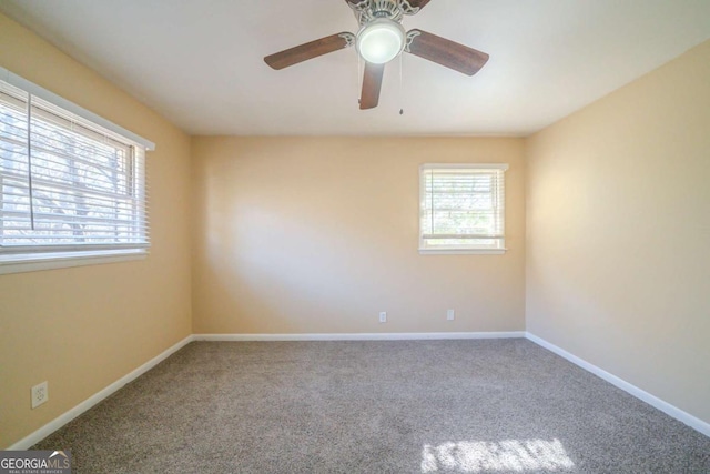 empty room featuring carpet floors and ceiling fan