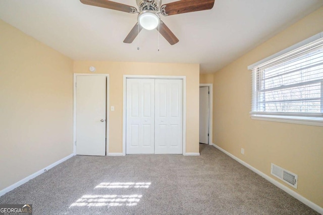 unfurnished bedroom featuring light carpet and ceiling fan