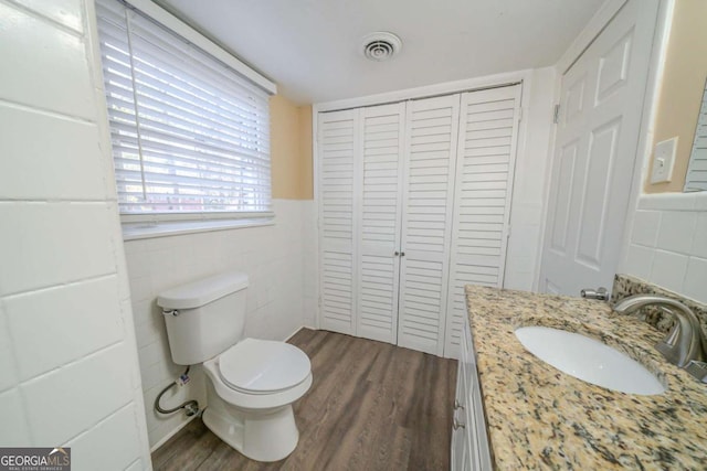 bathroom featuring vanity, toilet, and hardwood / wood-style floors