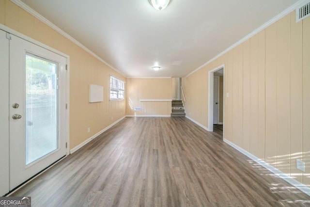 spare room featuring hardwood / wood-style flooring and crown molding