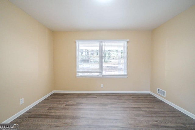 empty room with hardwood / wood-style flooring