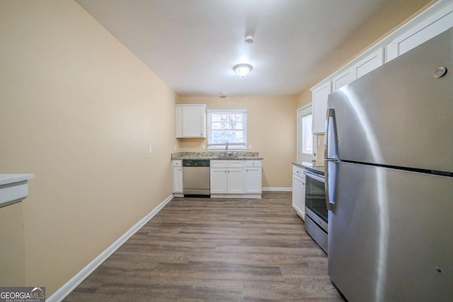 kitchen with white cabinetry, sink, hardwood / wood-style flooring, and stainless steel appliances