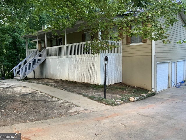 exterior space with a garage and covered porch