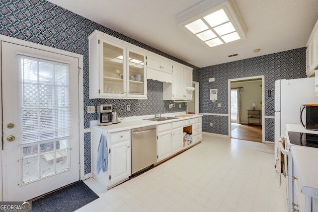 kitchen with white cabinetry, sink, and white appliances