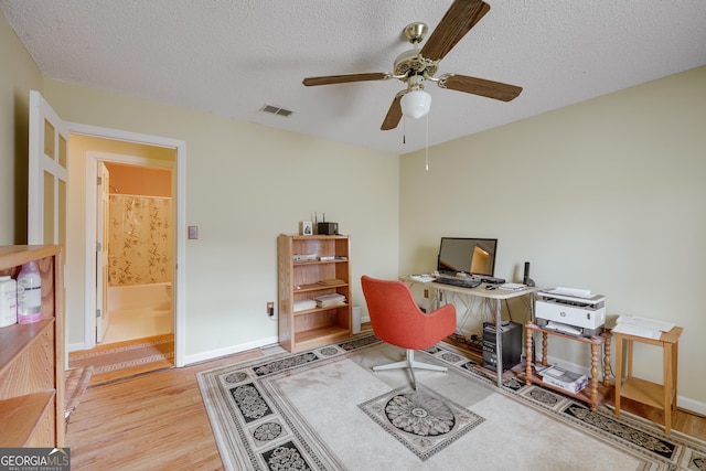 office featuring a textured ceiling and light hardwood / wood-style flooring