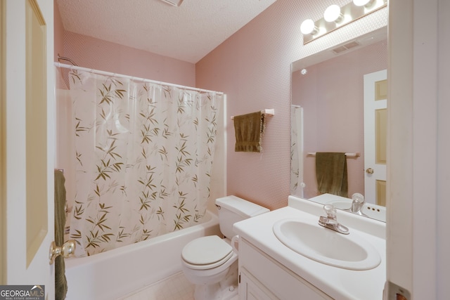 full bathroom with shower / bath combo, vanity, a textured ceiling, and toilet