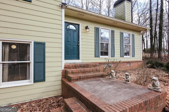 view of exterior entry featuring a patio