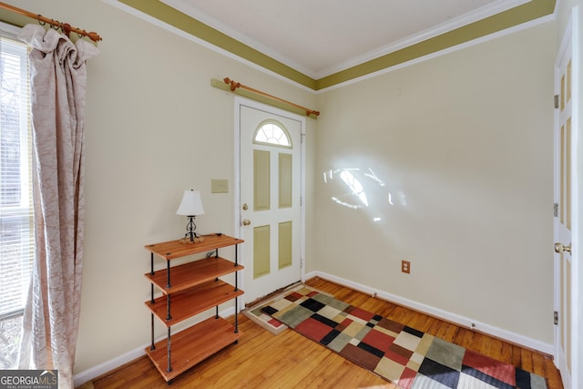 foyer entrance featuring hardwood / wood-style floors and ornamental molding