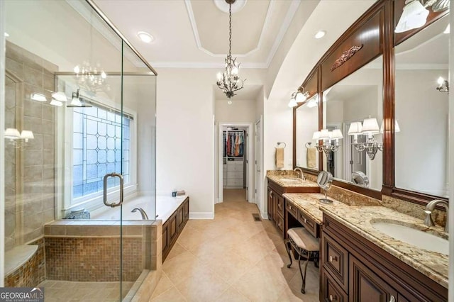 bathroom with tile patterned floors, a chandelier, independent shower and bath, and vanity