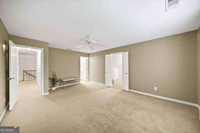 unfurnished room featuring ceiling fan and light carpet