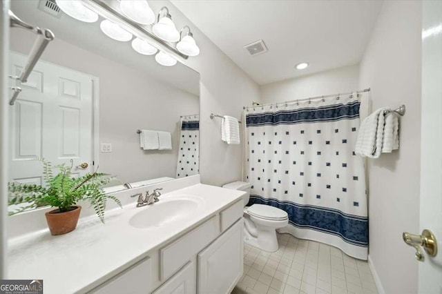 bathroom featuring vanity, tile patterned flooring, toilet, and walk in shower