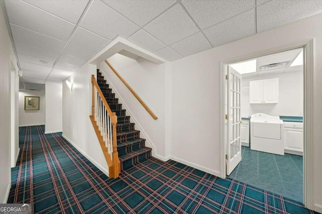 interior space featuring a paneled ceiling and washer / clothes dryer