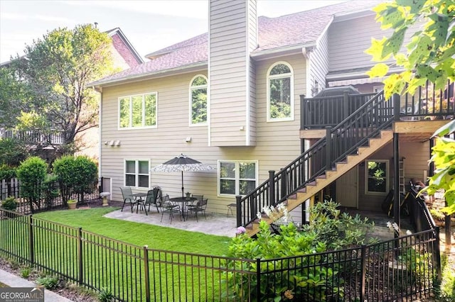 rear view of property featuring a yard and a patio