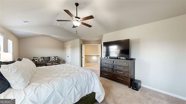 bedroom featuring light carpet, lofted ceiling, and ceiling fan