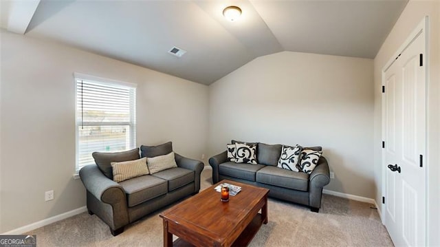 carpeted living room with vaulted ceiling