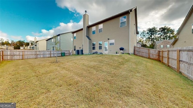 rear view of house with a yard