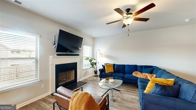 living room featuring ceiling fan and hardwood / wood-style floors