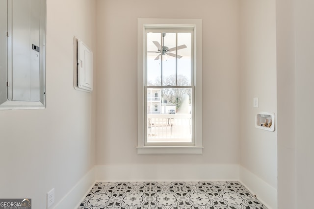 clothes washing area with ceiling fan, washer hookup, a healthy amount of sunlight, and electric panel