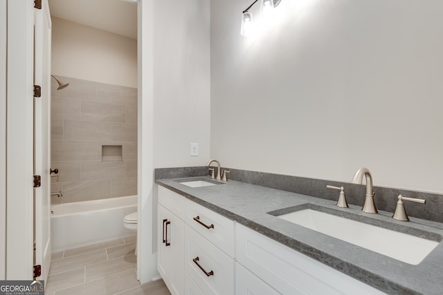 full bathroom with tiled shower / bath combo, vanity, tile patterned floors, and toilet