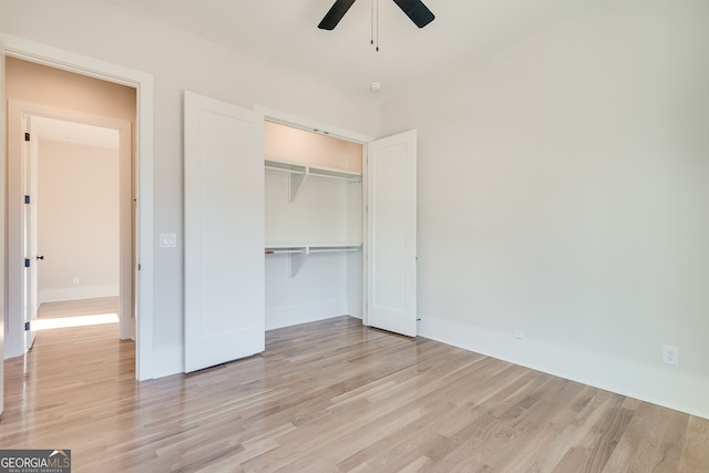 unfurnished bedroom with ceiling fan, a closet, and light hardwood / wood-style flooring