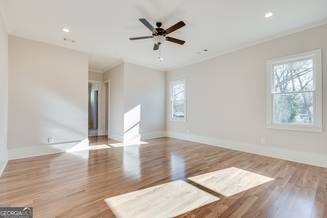 empty room featuring ornamental molding, ceiling fan, and light wood-type flooring