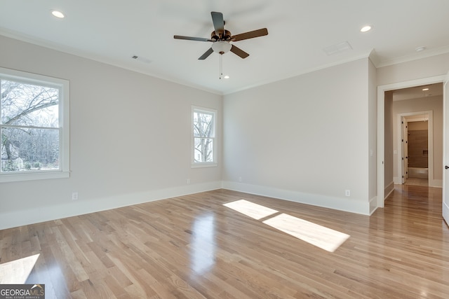 empty room featuring crown molding, ceiling fan, and light hardwood / wood-style flooring