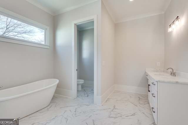 bathroom featuring vanity, a bathing tub, ornamental molding, and toilet