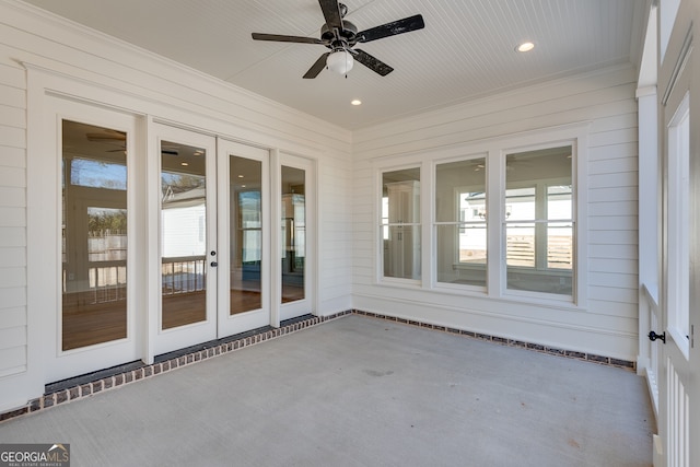 unfurnished sunroom featuring ceiling fan