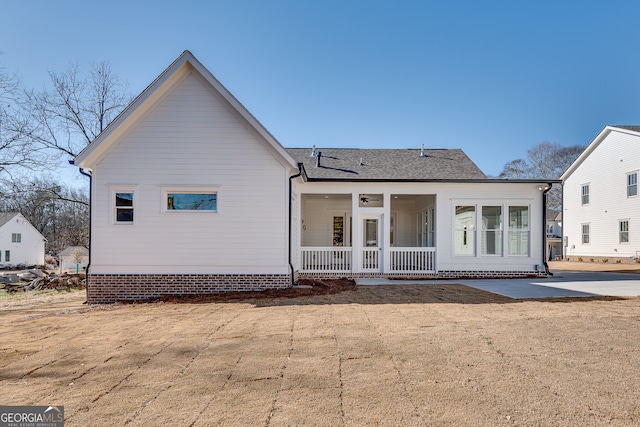 rear view of property with a porch, a yard, and ceiling fan