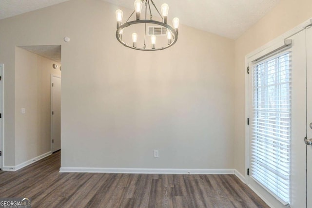 unfurnished dining area featuring a notable chandelier, vaulted ceiling, dark hardwood / wood-style floors, and a textured ceiling