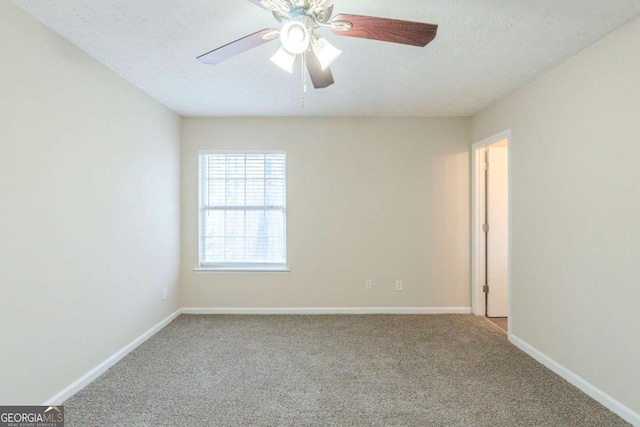 spare room with carpet, a textured ceiling, and ceiling fan