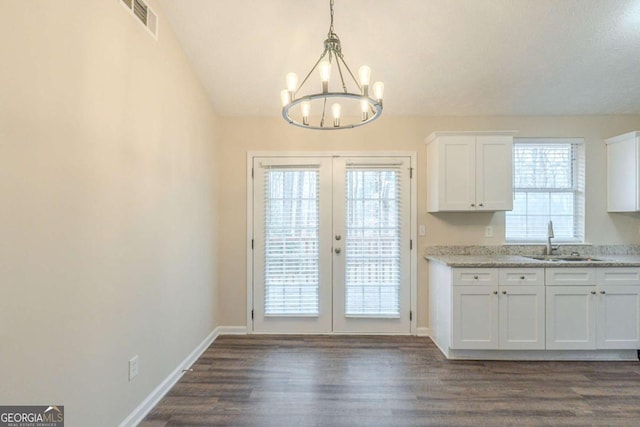 doorway with dark hardwood / wood-style flooring, sink, french doors, and an inviting chandelier