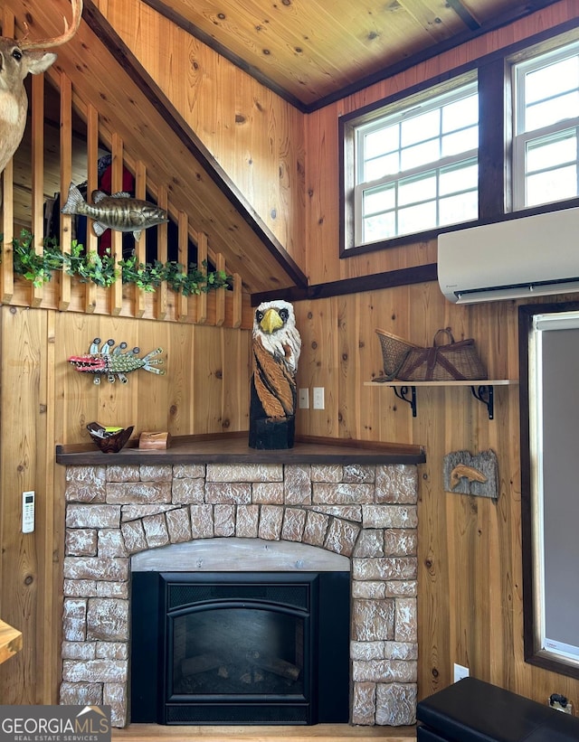 interior details with a wall mounted air conditioner, wood ceiling, a fireplace, and wood walls