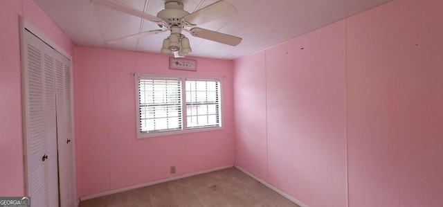 spare room featuring ceiling fan and light colored carpet