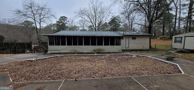 back of property with a sunroom