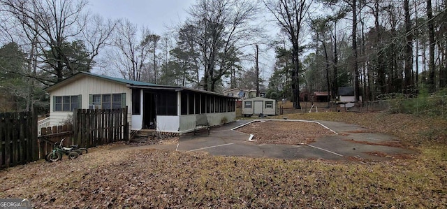 view of yard featuring a storage shed and a sunroom