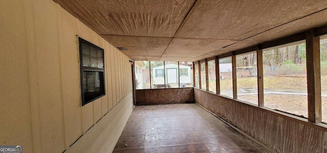 unfurnished sunroom featuring wooden ceiling