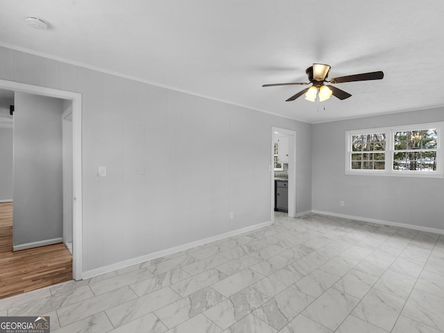 empty room with crown molding and ceiling fan