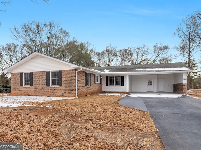 ranch-style house featuring a carport