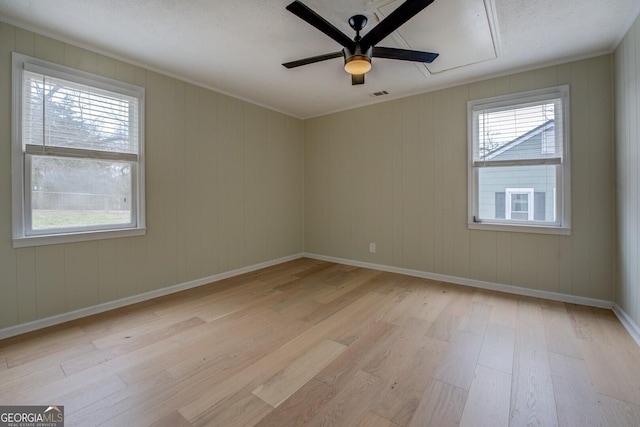 empty room with ceiling fan and light wood-type flooring