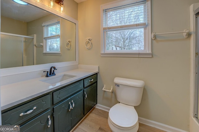 bathroom with walk in shower, vanity, toilet, and hardwood / wood-style flooring