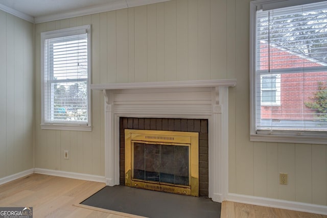 room details featuring hardwood / wood-style flooring, ornamental molding, and a fireplace