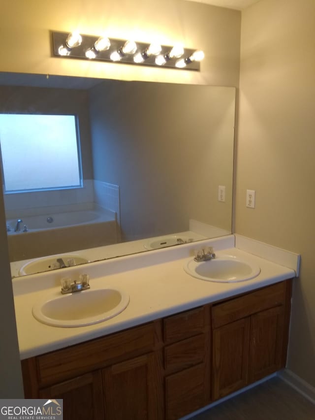 bathroom featuring vanity and a bath