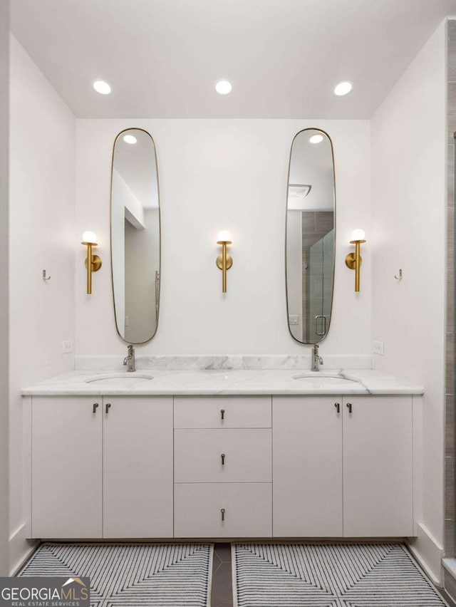 bathroom featuring vanity and an enclosed shower