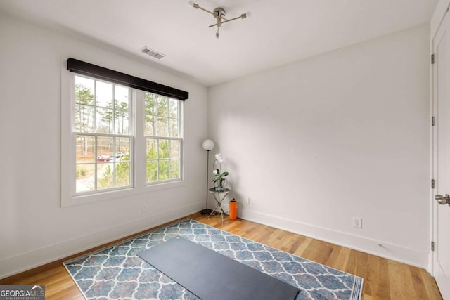 unfurnished room with hardwood / wood-style flooring